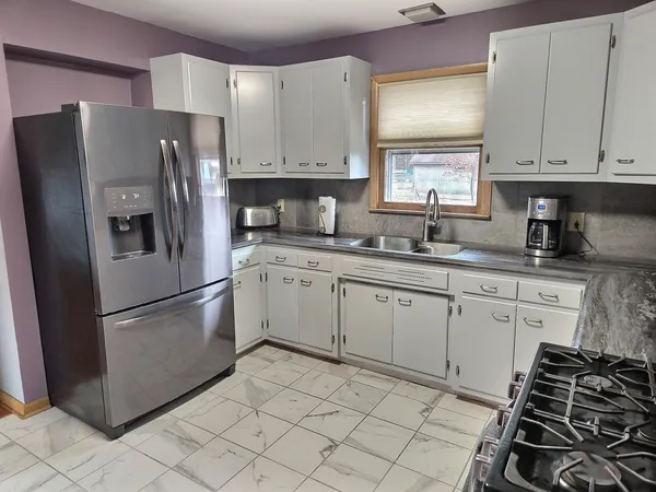 a kitchen with a sink stove and refrigerator