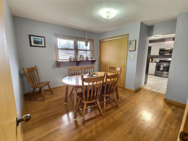 a view of a dining room with furniture and wooden floor