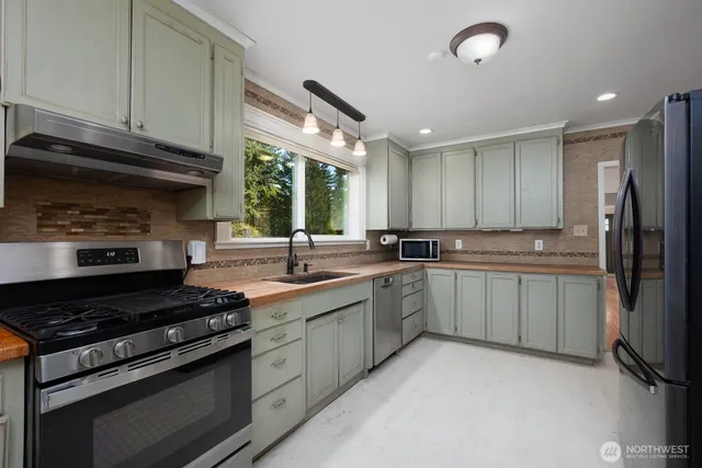 a kitchen with a sink stove and refrigerator