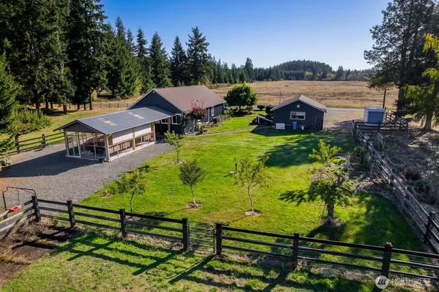 a view of a swimming pool with a patio and a garden