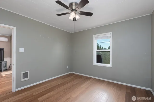 wooden floor in an empty room with a window