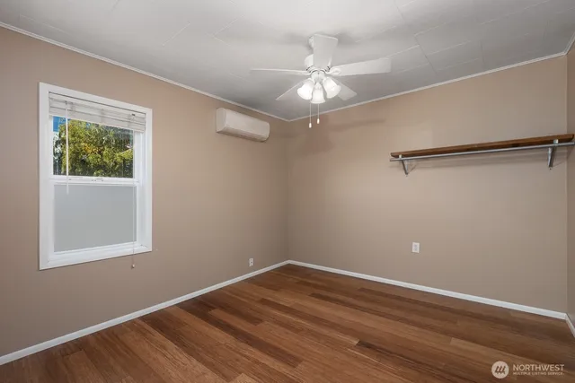 a view of a room with wooden floor closet and windows
