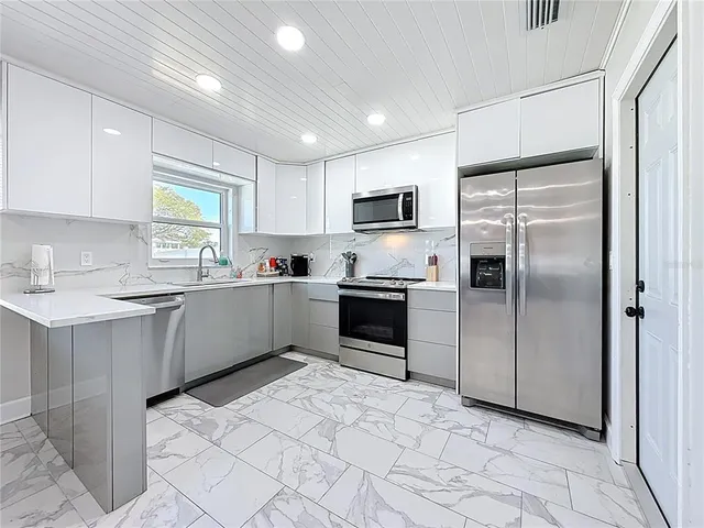 a bedroom with a bed and a lamp on dresser