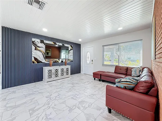 a bedroom with furniture and a flat screen tv