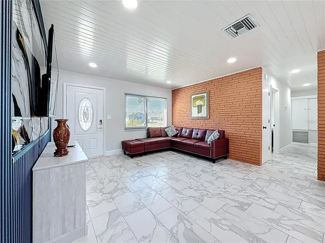 a bedroom with furniture and a flat screen tv