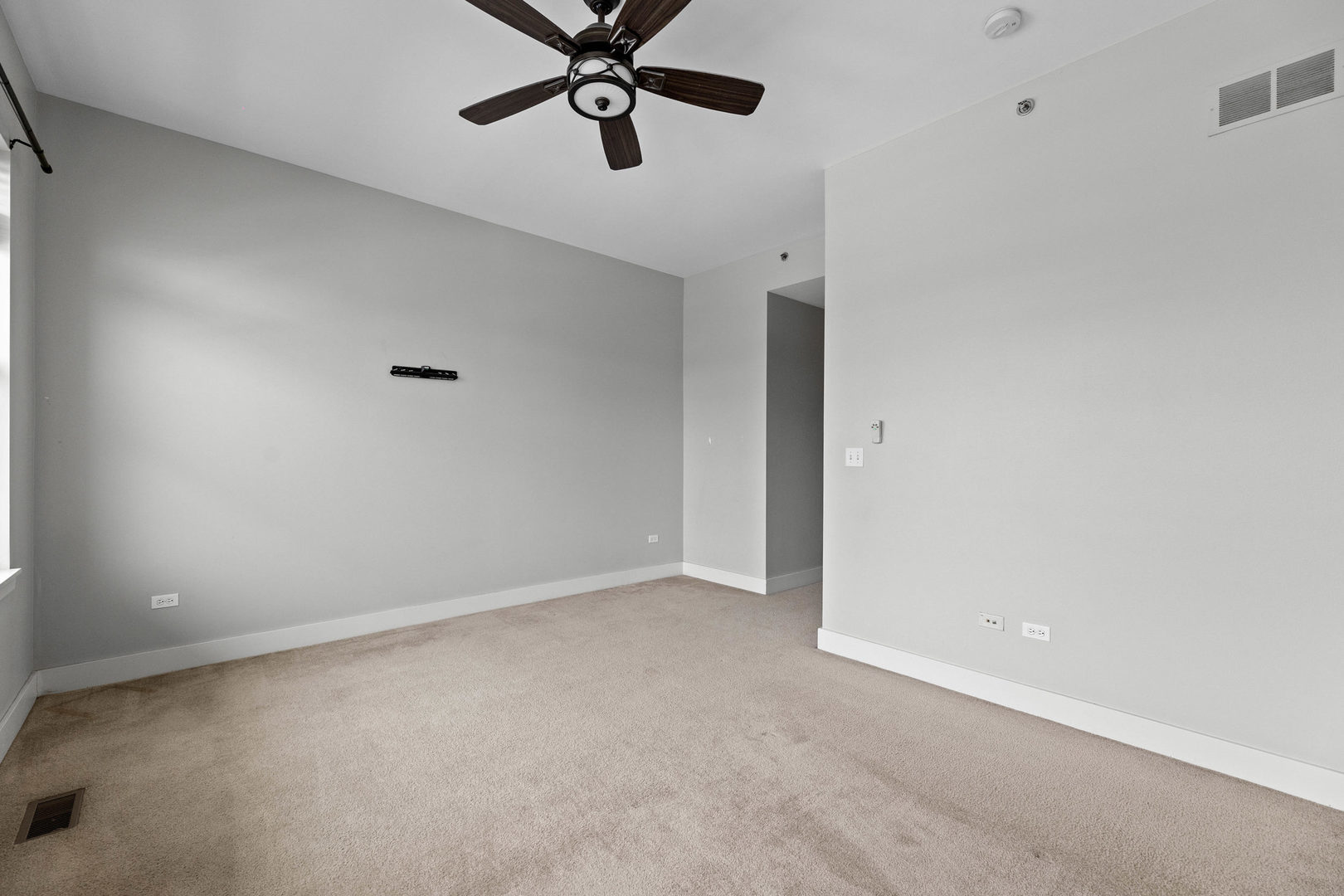 345 Front Street, Unit 2209 Lemont, IL 60439 - Photo 13 of 22 an empty room with a ceiling fan and window