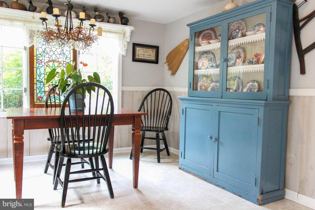 6401 Mackall Road St. Leonard, MD 20685 - Photo 23 of 30 a view of a dining room with furniture and a large window