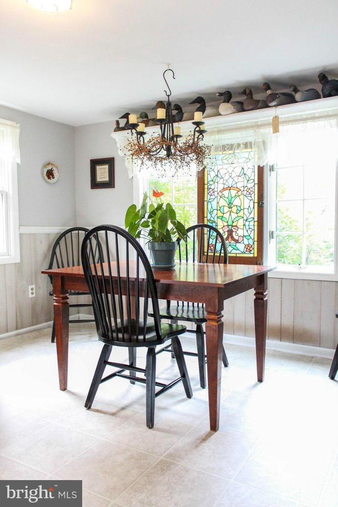 6401 Mackall Road St. Leonard, MD 20685 - Photo 24 of 30 a view of a dining room with furniture window and outside view