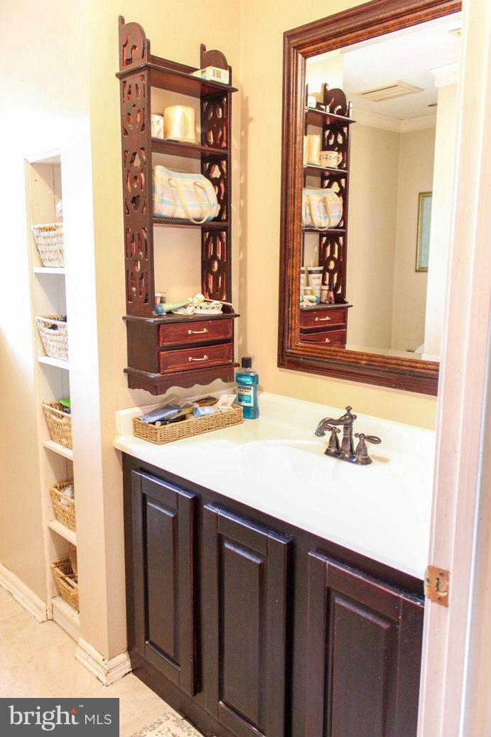 6401 Mackall Road St. Leonard, MD 20685 - Photo 27 of 30 a bathroom with a sink and a mirror