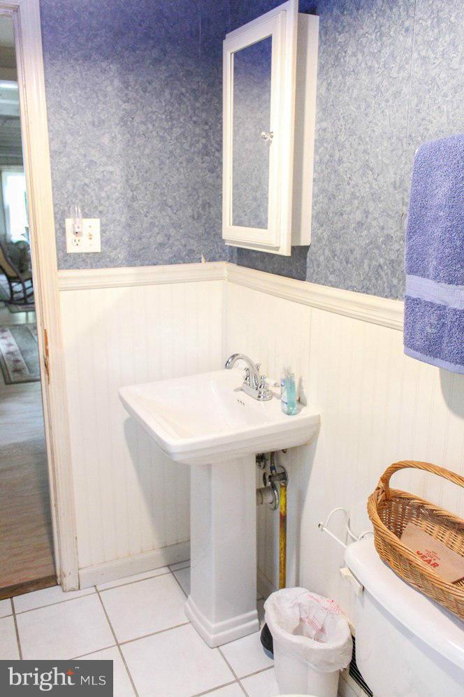 6401 Mackall Road St. Leonard, MD 20685 - Photo 29 of 30 a bathroom with a sink toilet and mirror