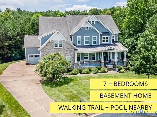 a view of a white house with a big yard and potted plants
