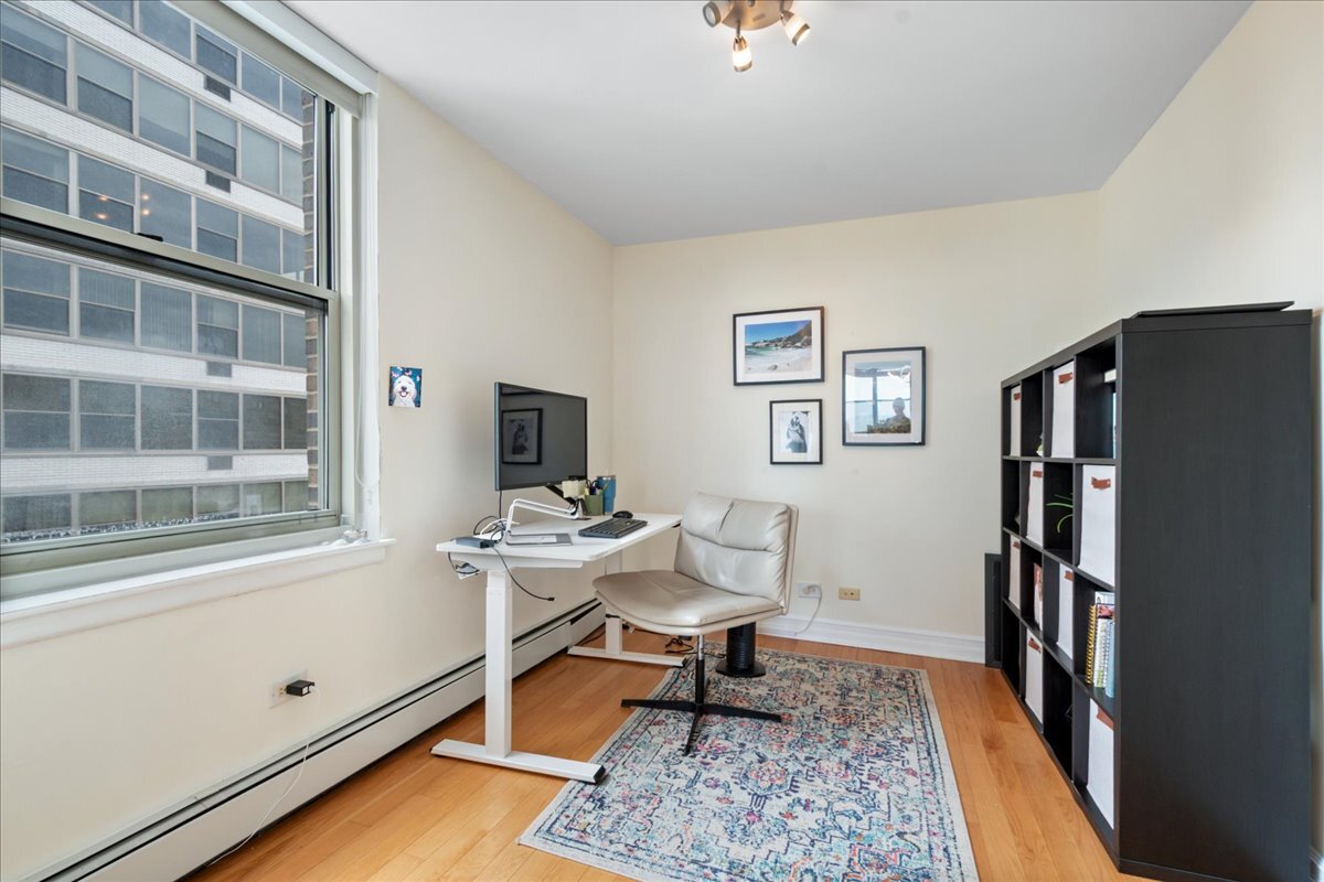 3033 North Sheridan Road, Unit 1605 Chicago, IL 60657 - Photo 11 of 21 a living room with furniture rug and a window
