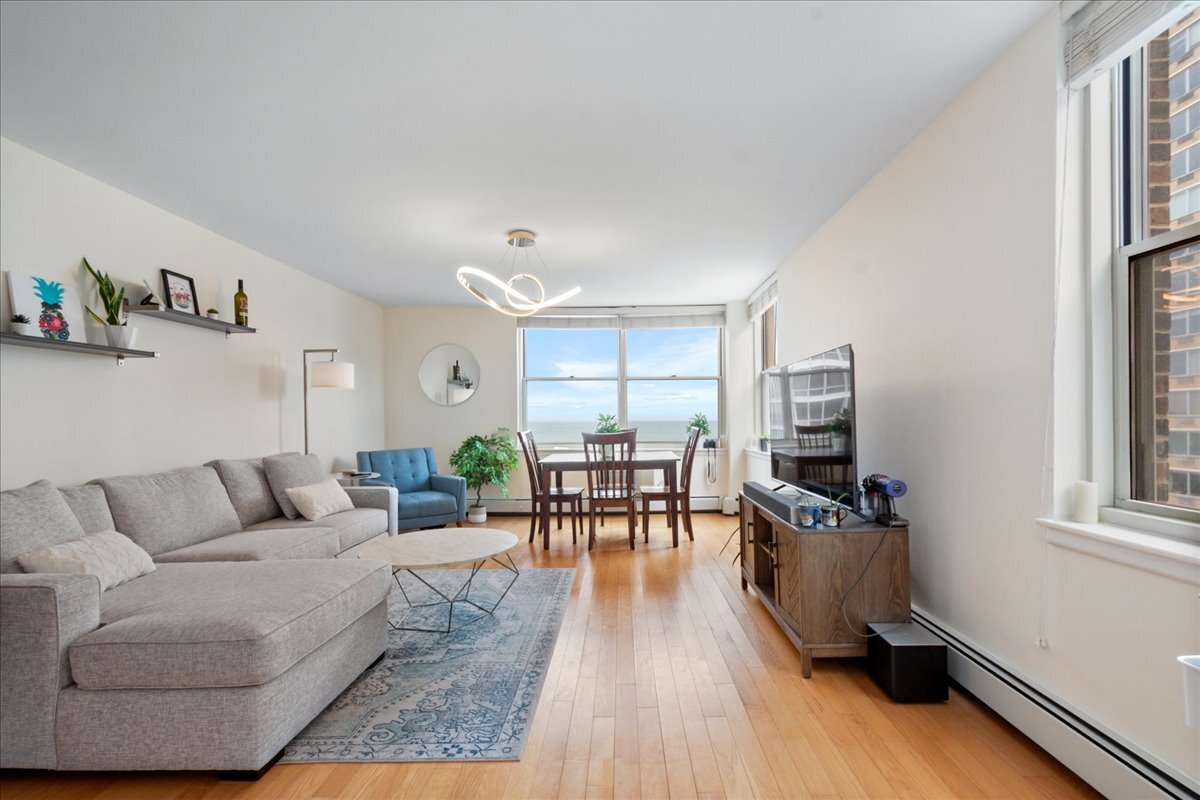 3033 North Sheridan Road, Unit 1605 Chicago, IL 60657 - Photo 4 of 21 a living room with furniture and a table