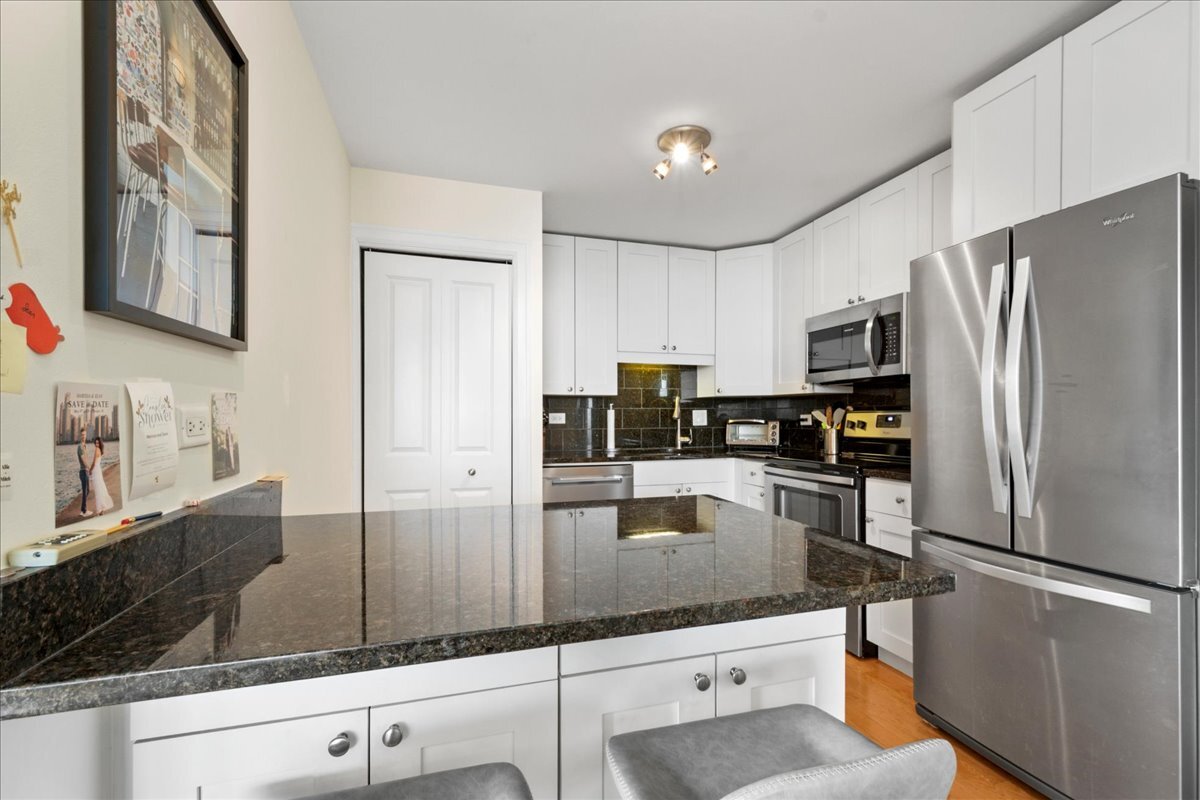 3033 North Sheridan Road, Unit 1605 Chicago, IL 60657 - Photo 8 of 21 a kitchen with stainless steel appliances granite countertop a refrigerator a stove and a sink