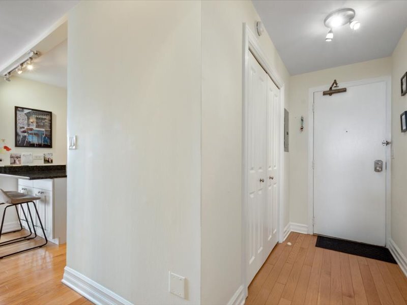 3033 North Sheridan Road, Unit 1605 Chicago, IL 60657 - Photo 10 of 21 a view of a hallway with wooden floor and a bathroom
