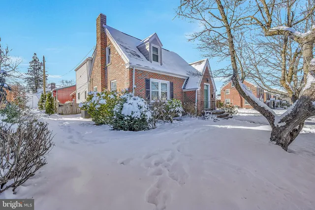 a front view of a house with yard and trees