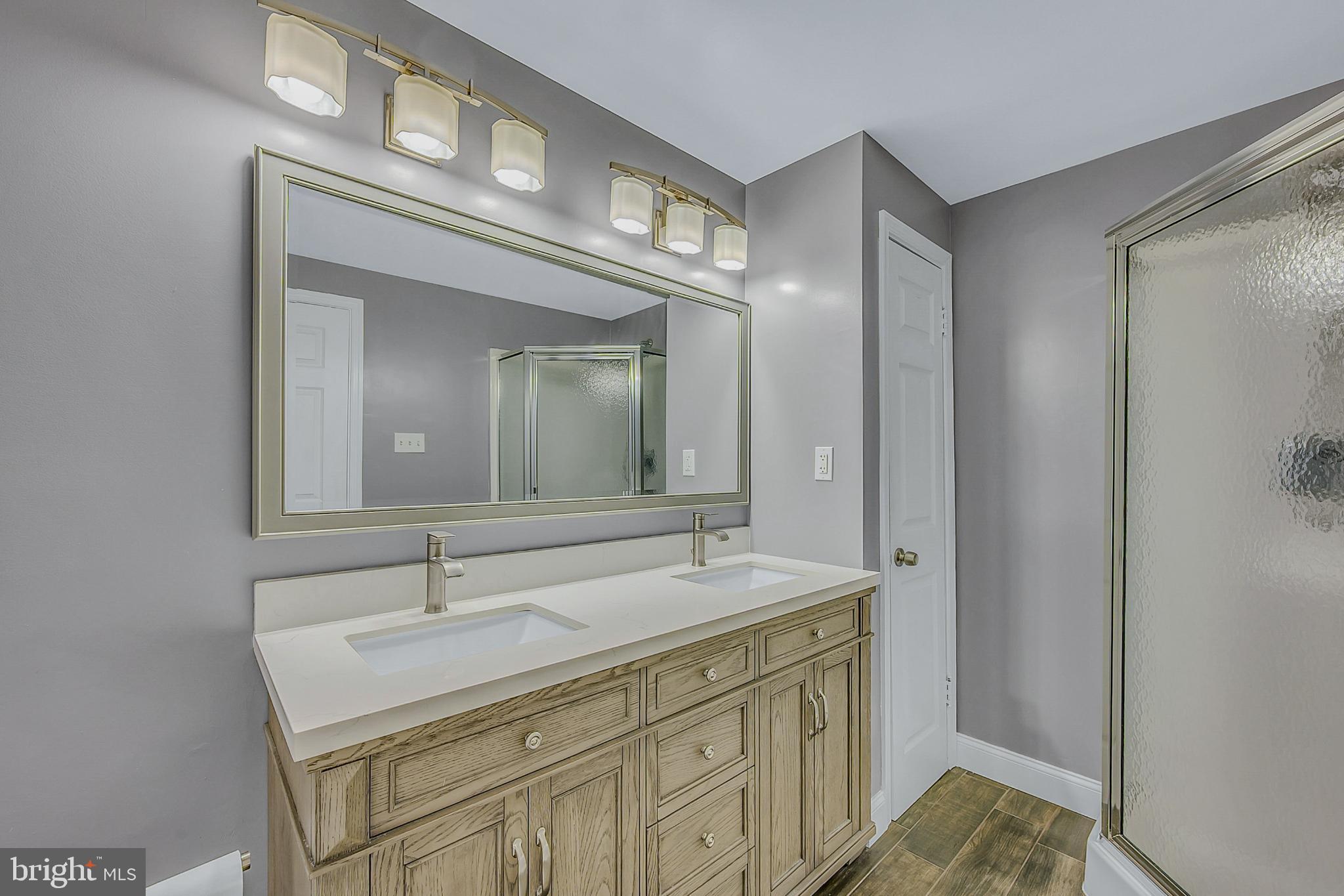 630 North 2nd Street Emmaus, PA 18049 - Photo 21 of 58 Elegant dual-sink bathroom with modern finishes.