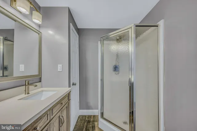 a bathroom with a bathtub a sink and a shower