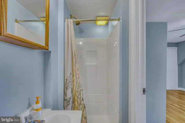 a view of empty room with wooden floor