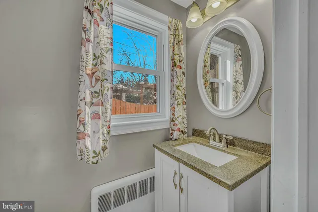 a view of a room with wooden floor and ceiling fan