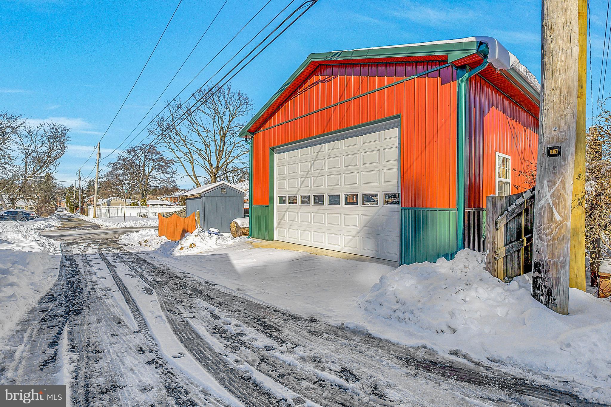 630 North 2nd Street Emmaus, PA 18049 - Photo 7 of 58 Vibrant garage nestled in a snowy landscape.