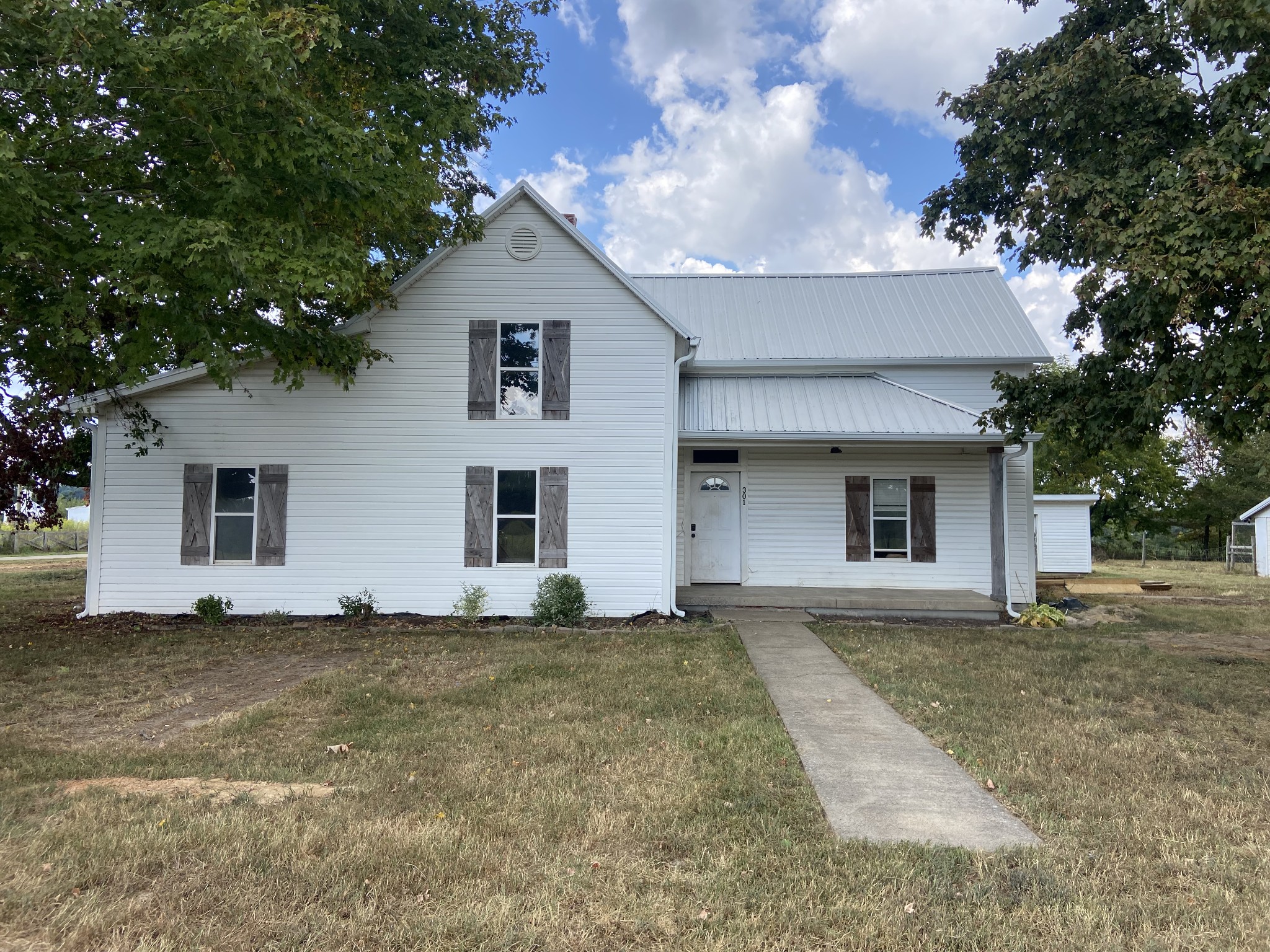 a house with lots of trees in the background