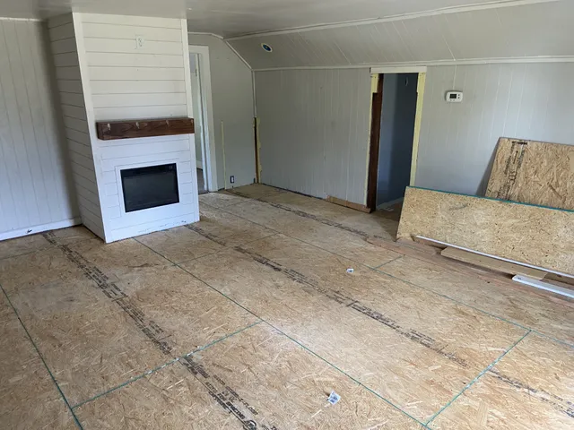 a bedroom with a bed and a fireplace