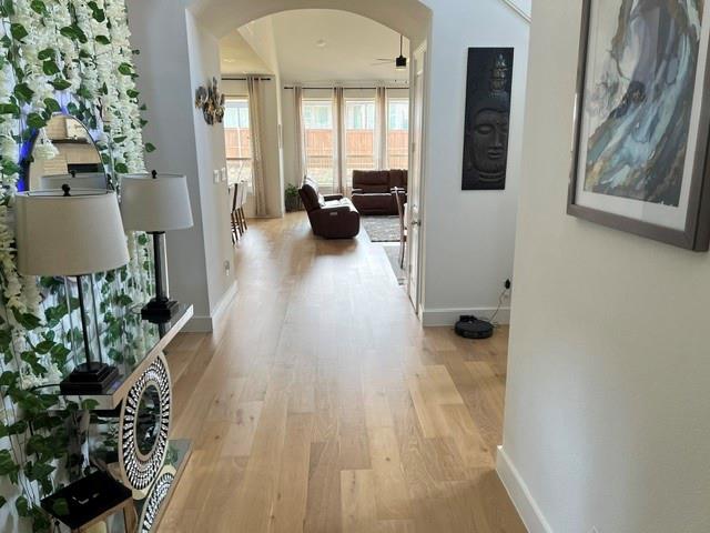 1407 Cartona Road Fate, TX 75087 - Photo 5 of 30 Archway entry leading to main living areas, featuring light wood-finish flooring throughout