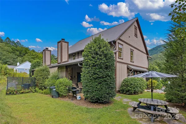 a view of a house with backyard garden and basketball court