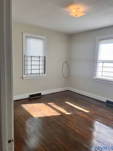 a view of a livingroom with wooden floor and window