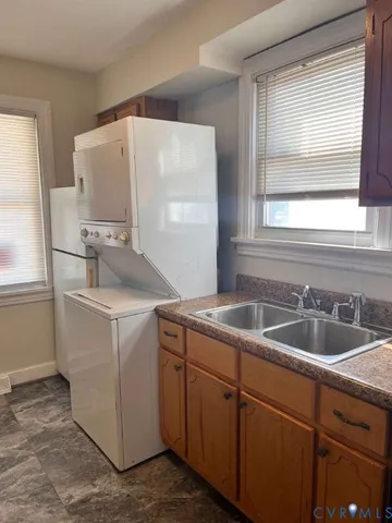 a utility room with sink dryer and washer