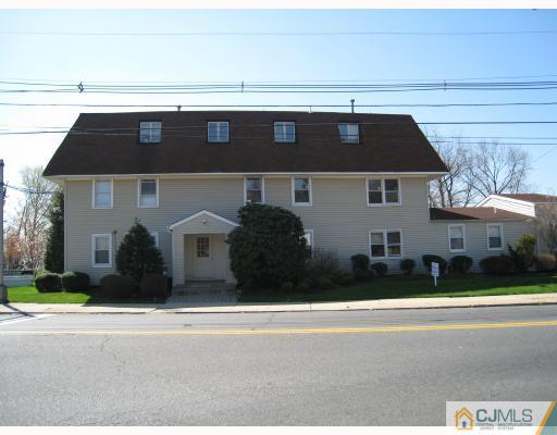 1 Racetrack Road, Unit 2 East Brunswick, NJ 08816 - Photo 1 of 1 a front view of a house with a yard and garage