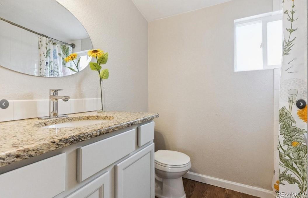 370 South Newton Street, Unit B Denver, CO 80219 - Photo 13 of 23 a bathroom with a granite countertop sink and a mirror