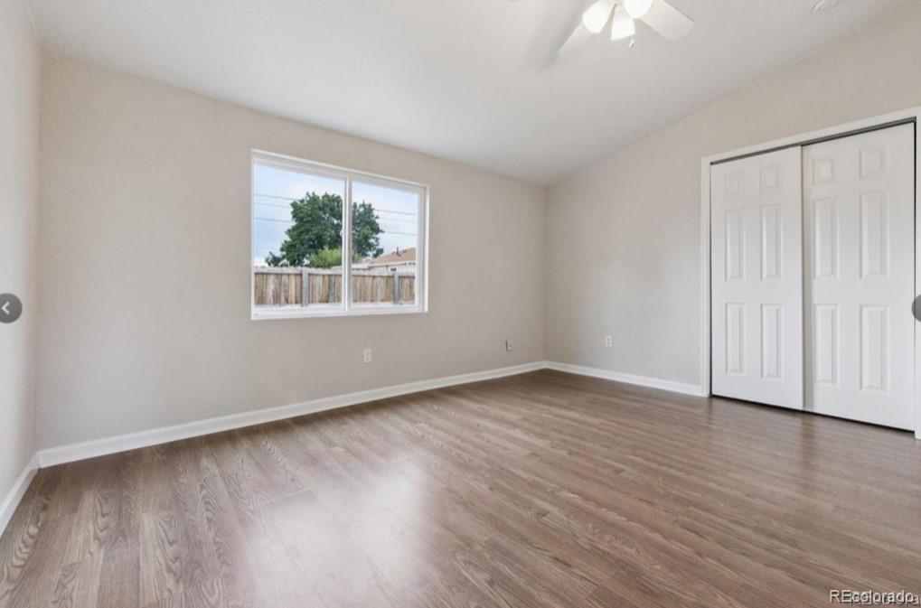 370 South Newton Street, Unit B Denver, CO 80219 - Photo 15 of 23 an empty room with wooden floor and windows