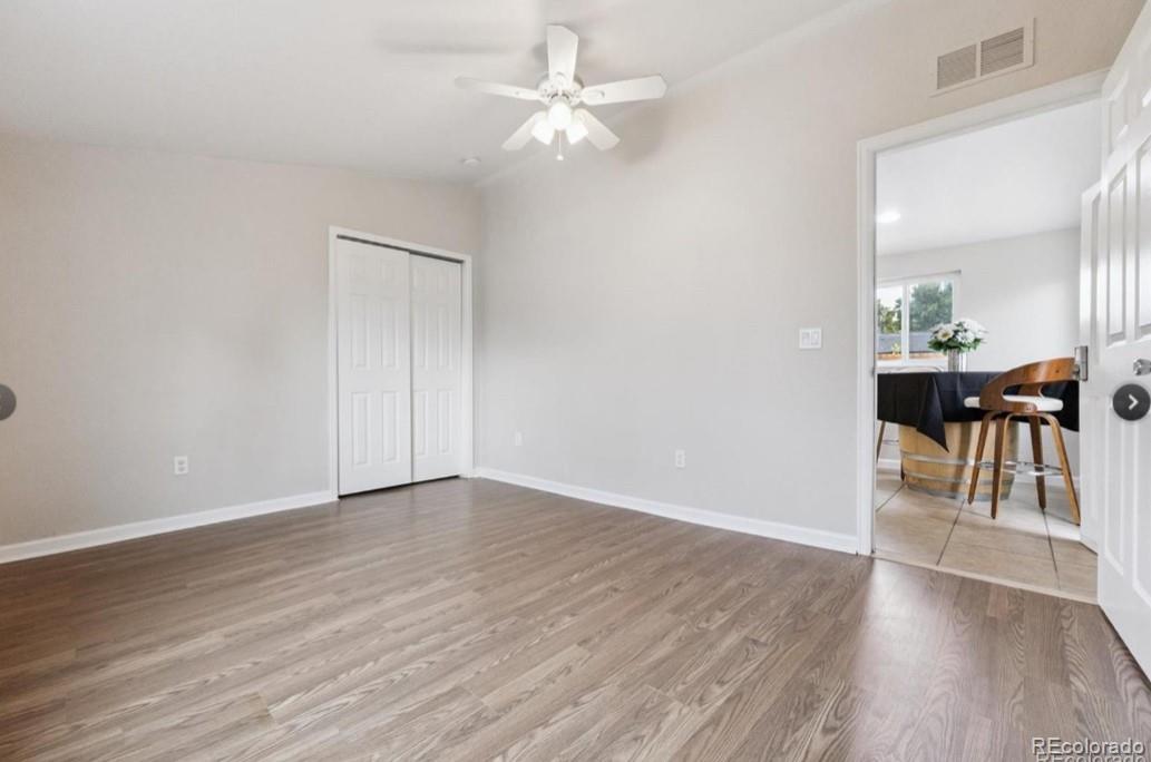 370 South Newton Street, Unit B Denver, CO 80219 - Photo 16 of 23 wooden floor in an empty room with a window