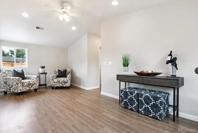 a living room with furniture and wooden floor
