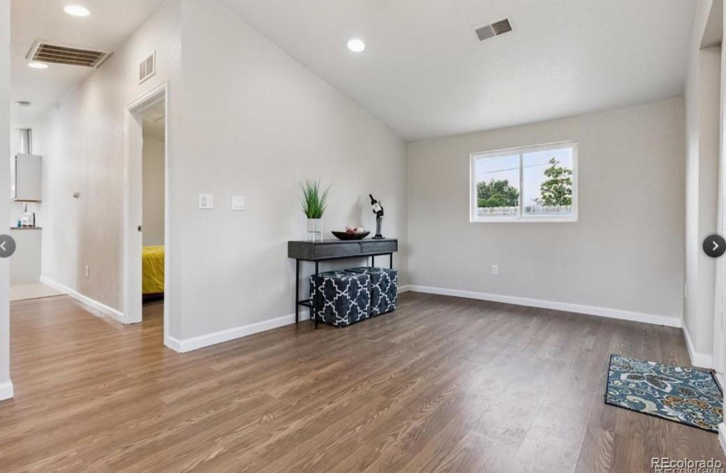 370 South Newton Street, Unit B Denver, CO 80219 - Photo 5 of 23 a view of an empty room and wooden floor