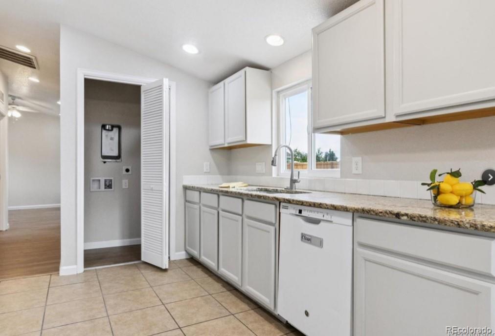 370 South Newton Street, Unit B Denver, CO 80219 - Photo 7 of 23 a kitchen with granite countertop white cabinets and a sink