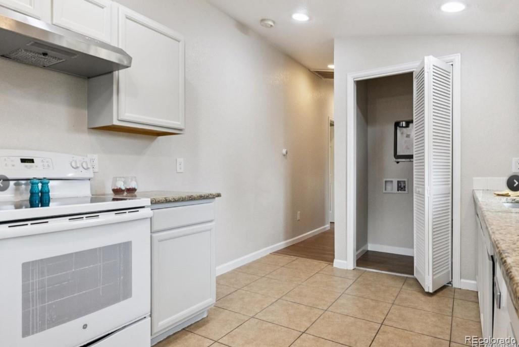 370 South Newton Street, Unit B Denver, CO 80219 - Photo 8 of 23 a kitchen with white cabinets and white appliances