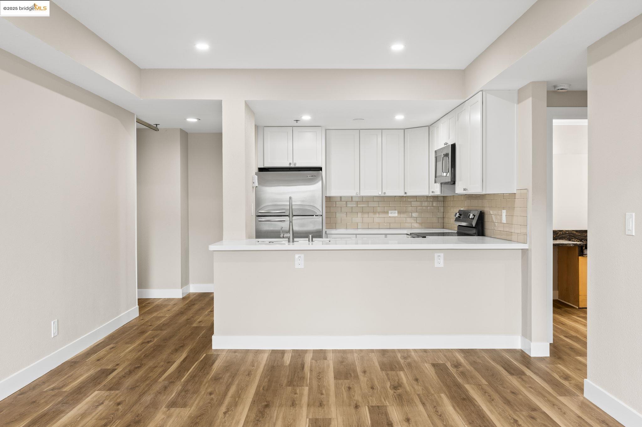 601 Van Ness Avenue, Unit 441 San Francisco, CA 94102 - Photo 13 of 58 a large kitchen with stainless steel appliances granite countertop a stove a sink and a refrigerator