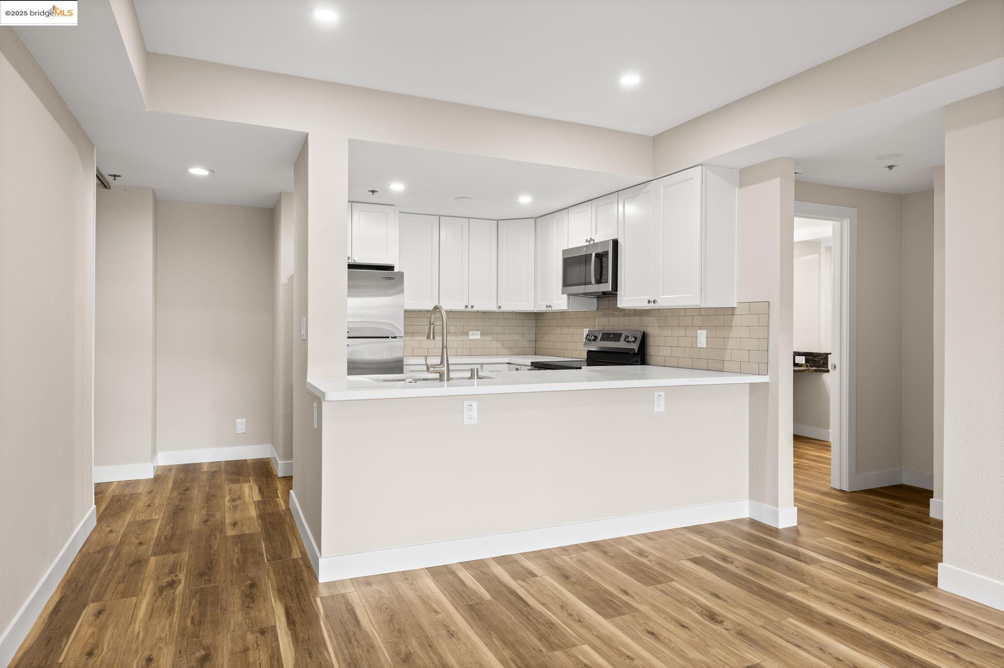 601 Van Ness Avenue, Unit 441 San Francisco, CA 94102 - Photo 14 of 58 a kitchen with stainless steel appliances granite countertop a stove a sink and a refrigerator
