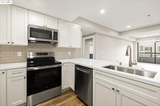 a kitchen with stainless steel appliances granite countertop a sink and a stove