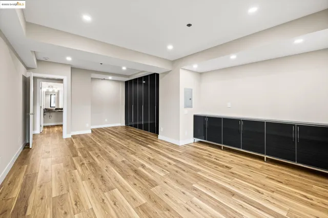 a view of an empty room with wooden floor