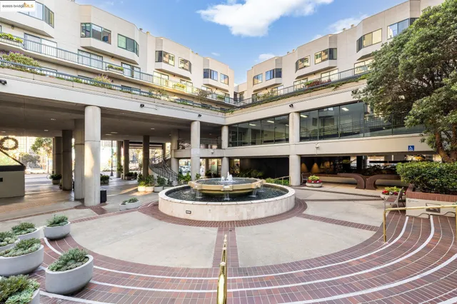 a room with lots of white furniture and a chandelier
