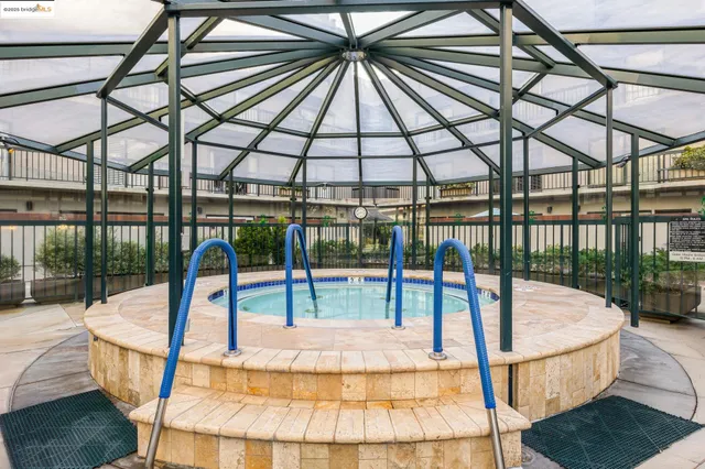 a living room with furniture a table and kitchen view
