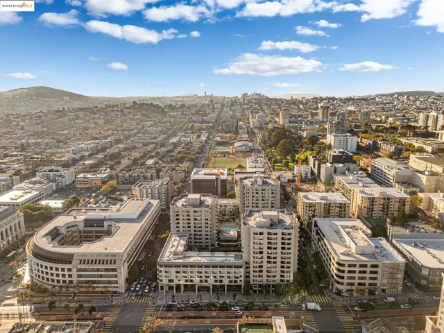 an aerial view of residential houses with city view