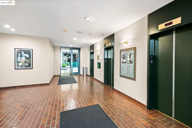 a view of a hallway with wooden floor and windows