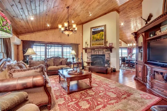 a living room with fireplace furniture and a chandelier