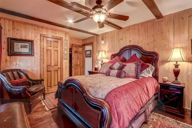 a bedroom with a bed and a dresser next to a window