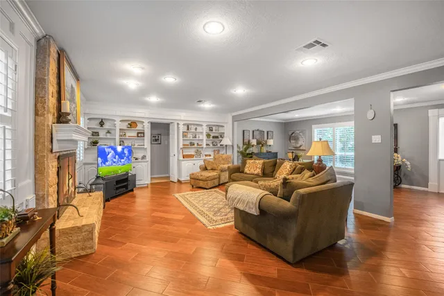 a living room with furniture fireplace and a flat screen tv